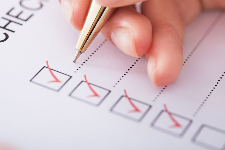 30059818 – cropped image of businesswoman writing on checklist
